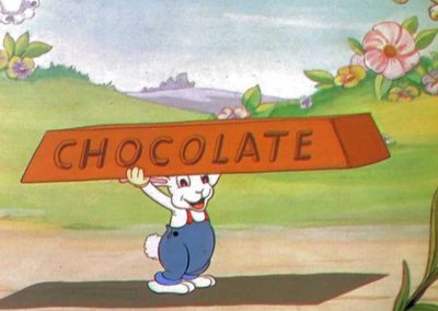 Un petit lapin transporte une barre de chocolat - Ma Folie Des Fetes